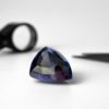 Dieser Tansanit in Triangel-Form und Troika-Schliff besitzt eine besondere Farbe: ein transparentes tiefes Violettblau mit Lila Akzenten. In dem transparenten Edelstein aus der Zoisit-Gruppe sind kleine Einschlüsse sichtbar.
