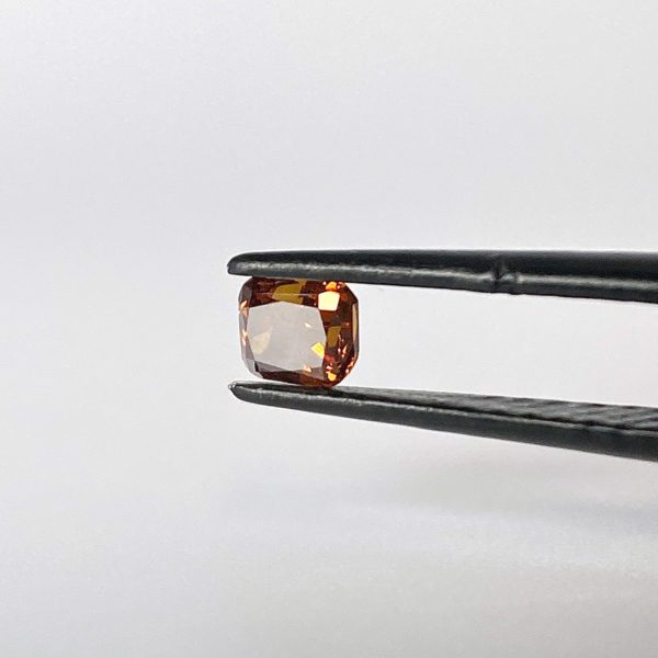 Dieser Edelstein ist ein orange-gelblicher Diamant im Cushion Cut.